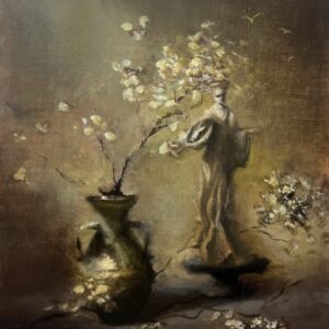 Statue with flowering branches in vase.